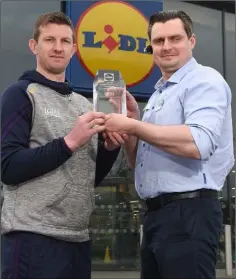  ??  ?? Anthony Masterson receiving the manager of the month award for March, 2018, from Darius Kacinskas, store manager of Lidl in Gorey.