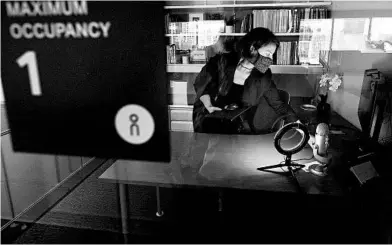  ?? STEVEN SENNE/AP ?? Rachel Zsembery arranges lighting at Bergmeyer. a design firm that is letting employees determine if they want to return to the office.