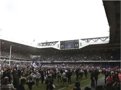  ??  ?? LONDON: Football fans invade the pitch after the English Premier League football match between Tottenham Hotspur and Manchester United at White Hart Lane. — AFP