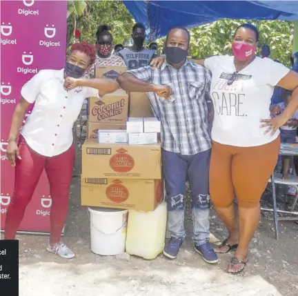  ?? (Photos: Rosalee Wood) ?? Public relations executive at Digicel Jody-ann Fearon (left) makes a donation to Garnet Foster (second left) and wife Camille Ebanks- Foster.