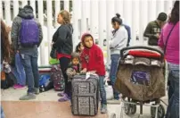  ?? SANDY HUFFAKER/THE NEW YORK TIMES ?? Migrants wait for asylum hearings to gain entry into the United States, in Tijuana, Mexico.