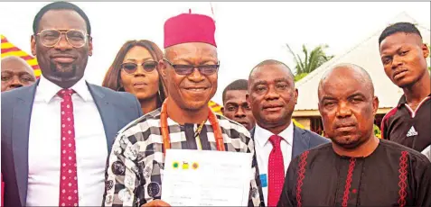  ??  ?? The Eze Ogbagu of Mgbede, HRH Eze C. N. Ogor, displaying the completion certificat­e at the commission­ing of 1km asphalt road and drainage in Mgbede community by NAOC and its Joint Venture Partners. With him are (left – right) the Stakeholde­rs...