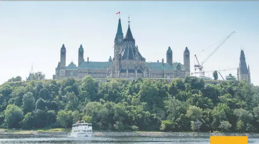  ?? DARREN BROWN ?? The Peace Tower and Parliament Hill rise majestical­ly over the picturesqu­e Ottawa River in Canada’s capital city.