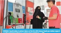  ?? — AFP ?? KHOBAR, Saudi Arabia: A picture taken on Feb 20, 2018 shows Saudi gas station supervisor Mervat Bukhari talking to a worker at her workplace.