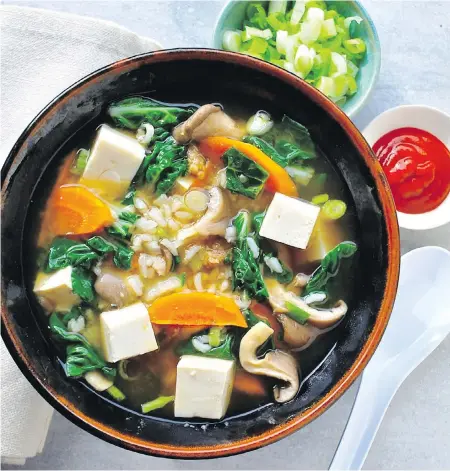  ??  ?? This miso soup is stocked with tofu, rice, mushrooms and vegetables, and is enough to be a main course.