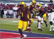  ?? RICK SCUTERI – THE ASSOCIATED PRESS ?? DeaMonte Trayanum scores one of Arizona State’s seven rushing touchdowns against rival Arizona on Friday.