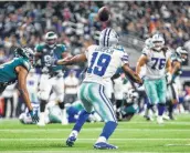  ?? Ashley Landis / TNS ?? Cowboys receiver Amari Cooper prepares to catch a deflected pass that led to a game-winning TD in OT.