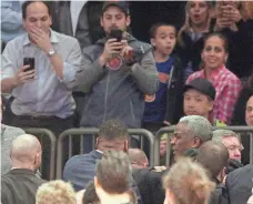  ?? BRAD PENNER, USA TODAY SPORTS ?? Former Knick Charles Oakley, lower right, is removed from his seat during the first quarter of the Knicks game Wednesday.