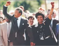  ?? AP PHOTO ?? Nelson Mandela and wife Winnie walk hand in hand, raising their clenched fists upon his release from Victor prison, on Feb. 11, 1990, in Cape Town.