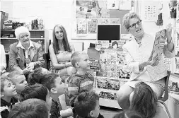  ?? Colin Perkel / THE CANADIAN PRESS ?? Ontario Premier Kathleen Wynne reads a story to kindergart­en students during a campaign stop in 2014.