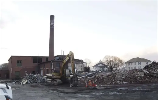  ?? Photos by Joseph B. Nadeau ?? It won’t be long before the Bonin Spinning Co. mill on Mendon Road is just memory thanks to an ongoing demolition project at the site. The building’s owners opted to remove the deteriorat­ed mill as the best option for future use of the property.