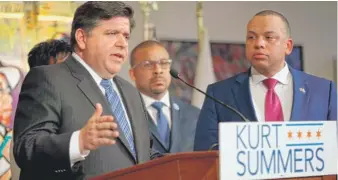  ??  ?? J. B. Pritzker ( left) accepts the endorsemen­t of Chicago City Treasurer Kurt Summers on Wednesday at Gallery Guichard in Chicago.
| KEVIN TANAKA/ FOR THE SUN- TIMES