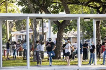  ?? DANIEL A. VARELA dvarela@miamiheral­d.com ?? People line up for vaccinatio­ns at the new FEMA-supported, state-run COVID-19 vaccine satellite site inside the Samuel K. Johnson Youth Center at Charles Hadley Park in Liberty City on Friday.