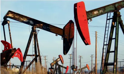  ?? — AFP ?? Pump jacks and wells are seen in an oil field on the Monterey Shale formation where gas and oil extraction using hydraulic fracturing, or fracking, near McKittrick, California. Market anticipati­on of the agreement between Opec and its friends in November last year, and the actual deal, lifted WTI from a record low level of $26 in early 2016.