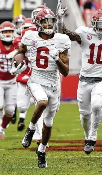  ?? Michael Woods / Associated Press ?? Alabama’s Devonta Smith, returning a punt for a touchdown against Arkansas, led the nation with 105 catches and 20 scores.