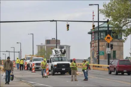  ?? ERIC BONZAR — THE MORNING JOURNAL ?? A crew from Richfield-based American Roadway Logistics Inc. marks out lanes May 21, 2018, on the Charles Berry Bascule Bridge over the Black River in Lorain. Traffic on the bridge was reduced to one lane in both directions as the $26.3 million...