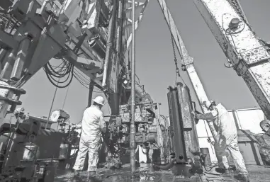  ?? NATHAN J. FISH/THE OKLAHOMAN FILE ?? Motorhands pull pipe on a Charter Oak Production oil rig in 2022 in Newcastle.