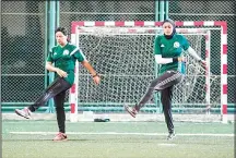  ??  ?? Egyptian referee Hanan Hassan (right), and assistant referee Mona Atalla warm up prior to a women’s football match in Cairo on June 3, 2018. (AFP)