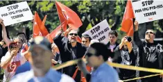  ??  ?? Pro-erdogan demonstrat­ors outside the ambassador’s residence, where fights broke out between rival factions, below