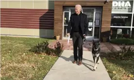  ?? Photograph: Stephanie Carter/AP ?? Joe Biden leaving the Delaware Humane Associatio­n with his German shepherd, Major.