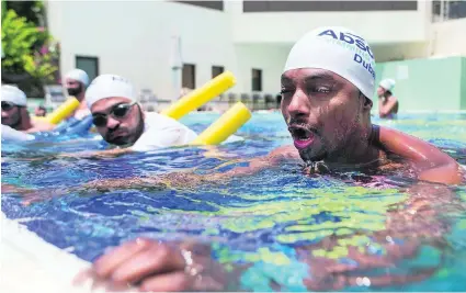  ?? Christophe­r Pike / The National ?? Kenyan Eddie Umar, 35, learns to swim despite his fear of water at the Le Meriden Hotel in Dubai on Wednesday.