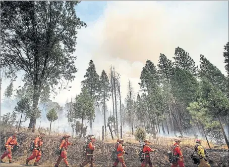  ?? GETTY IMAGES ?? Inmate firefighte­rs battle the Ferguson fire in the Jerseydale area on Sunday. The wildfire burning on the western edge of Yosemite National Park has generated so much smoke that air pollution levels in Yosemite Valley are worse than in Beijing, one of the world’s most polluted cities, officials say.