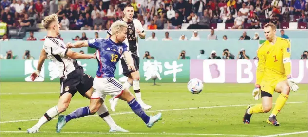  ?? ?? Japan’s Takuma Asano scores a goal against Germany during their Group E match on Wednesday.