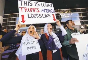  ?? Al Seib Los Angeles Times ?? NOOR HINDI, left, and Shah Najjar rally at LAX in 2017 against the travel ban on Muslim-majority nations.