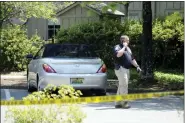  ?? JAY REEVES-ASSOCIATED PRESS ?? A police officer walks outside St. Stephen’s Episcopal Church in Vestavia Hills, Ala., on Friday. Authoritie­s say two people were shot to death and a third was wounded during an evening gathering when a man pulled out a handgun and began firing.