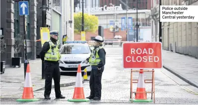  ??  ?? Police outside Manchester Central yesterday