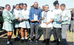  ?? Picture: Sue Maclennan ?? SERIOUS MATTERS: Author and financial literacy activist Mlamluli Mbambo, centre, talked to learners from Velile Secondary School in Nolukhanyo. He was there alongside a delegation from the United Arab Emirates Embassy. Velile was the 17th school in SA to receive a visit and donations from the embassy