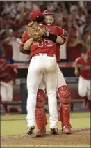  ?? AP photo ?? Angels catcher Dustin Garneau hugs Felix Pena after Pena and Taylor Cole combined to pitch a no-hitter in a 13-0 win over the Mariners on Friday.