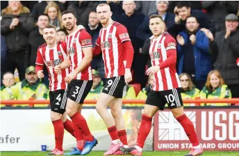  ?? — AFP photo ?? Sheffield United’s Enda Stevens (second left) celebrates with teammates after scoring against Brighton and Hove Albion during their English Premier League match at Bramall Lane in Sheffield, in this Feb 22 file photo.