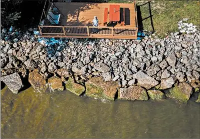  ?? ZBIGNIEW BZDAK/CHICAGO TRIBUNE PHOTOS ?? Nancy Sullivan stands on her deck along the shore of Lake Ontario in Greece, New York. She said her basement flooded multiple times.