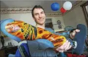  ?? DIGITAL FIRST MEDIA FILE ?? In this 2014 photo, Topton native Tyler Carter shows his custom-made prosthesis cast in fiberglass ahead of competing in the Paralympic Games in Sochi.