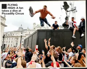  ??  ?? FLYING HIGH: A fan takes a dive at Piccadilly Circus