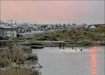  ??  ?? The sun sets over the UN camp in Malakal, home to up to 30,000 people. Conditions there were even worse than in Pibor, and tensions between residents and peacekeepe­rs were high.