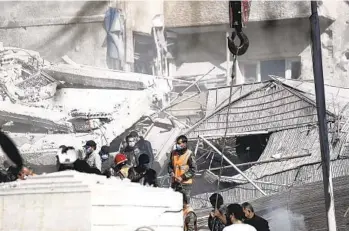  ?? OMAR SANADIKI AP ?? Emergency personnel work at a building hit by an Israeli airstrike in Damascus, Syria, on Saturday. Syrian and Iranian state media outlets say the airstrike killed at least five Iranians.