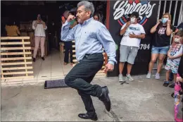  ??  ?? Fabio Rodolfo Vasquez dances Saturday with his wife, Maria Moreno, outside of frame, at a promotiona­l event outside a coffee shop, on the outskirts of Guatemala City. The couple entered an online dance contest during the new coronaviru­s pandemic to help them cope with the recent death of their daughter — and won it.