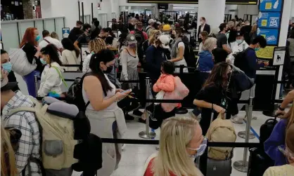  ?? Photograph: Joe Raedle/Getty Images ?? People wait at Miami internatio­nal airport security on Wednesday.