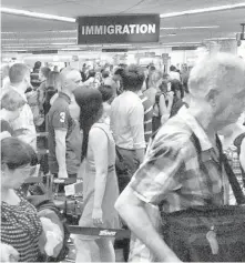  ?? PHILSTAR.COM ?? Foreigners join queues at immigratio­n counters at the Ninoy Aquino Internatio­nal Airport.