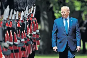  ??  ?? Mr Trump inspects a guard of honour shortly after arriving at Buckingham Palace yesterday, above. Later, he was driven down The Mall in his armoured Cadillac, nicknamed The Beast, right, before visiting the grave of The Unknown Warrior at Westminste­r Abbey, far right