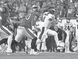  ?? KIM KLEMENT NEITZEL/USA TODAY SPORTS ?? Eagles quarterbac­k Jalen Hurts (1) runs with the ball against the Buccaneers during the first half of a game earlier this season at Raymond James Stadium.