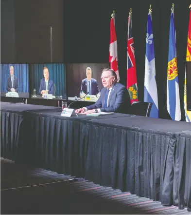  ?? RYAN REMIORZ / THE CANADIAN PRESS ?? Quebec Premier François Legault chairs a premiers virtual news conference Thursday in Montreal. The premiers
seen onscreen from the left are: John Horgan, B.C., Jason Kenney, Alberta, and Scott Moe, Saskatchew­an.