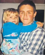  ??  ?? Amelia Adlam, as a child, in the arms of her stepbrothe­r, Andrew Harper, a police officer who died while responding to the report of a burglary