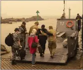  ?? AUSTRALIA DEPARTMENT OF DEFENSE VIA AP ?? Evacuees board landing craft to be ferried out to an Australian navy ship on Friday in Mallacoota, Australia.