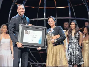  ??  ?? Receiving the ethekwini Living Legends Award from SA Olympic swimming champion, Chad Le Clos.
