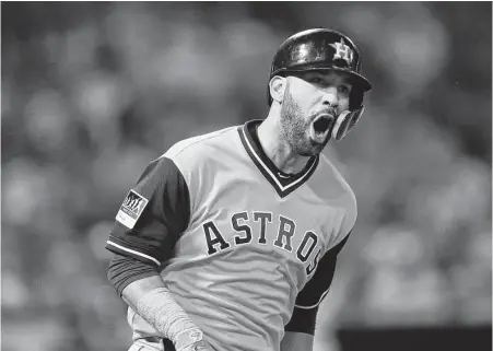  ?? Jae C. Hong / Associated Press ?? The Astros’ Marwin Gonzalez happily cleans up after himself by clearing the bases with a grand slam during the fifth inning Friday night against the Angels.