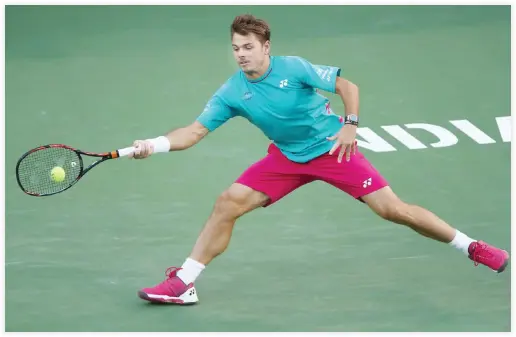  ??  ?? Stanislas Wawrinka plays a forehand against Philipp Kohlschrei­ber in their third round match at Indian Wells Tennis Garden on Monday night. (AFP)