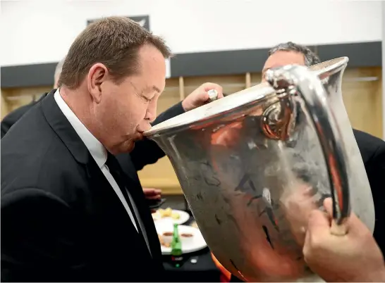  ?? PHOTO: GETTY IMAGES ?? Steve Hansen takes a drink from the vast Bledisloe Cup which remains firmly in the All Blacks’ hands after Saturday’s convincing win in Wellington.